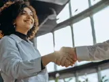 Smiling woman shaking hands with a provider